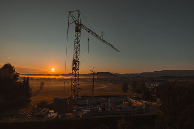 Crane against sky during sunset