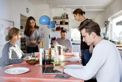 Family at dining table in new house