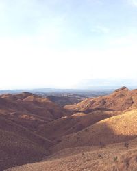 Scenic view of arid landscape against sky