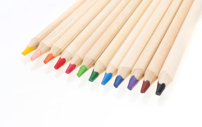 Close-up of colored pencils against white background