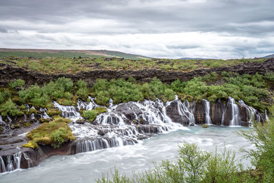 Scenic view of river flowing through rocks