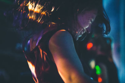 Happy woman dancing at nightclub