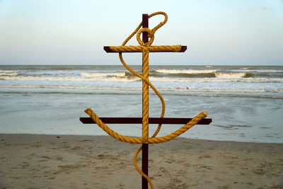 Lifeguard hut on beach against sky