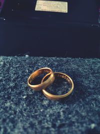 Close-up of wedding rings on table