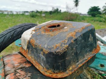 Close-up of rusty metal on field