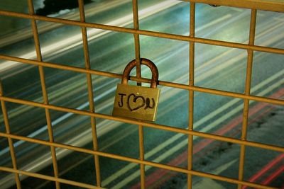 Close-up of padlocks hanging on metal chain