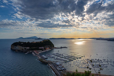 High angle view of bay against sky at sunset
