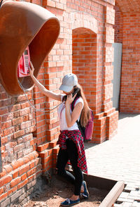 Girl stands at the telephone booth