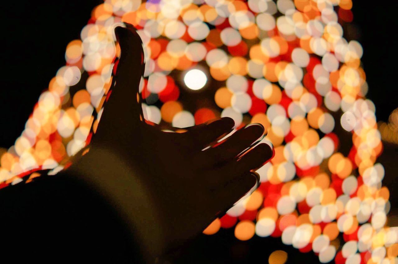 close-up, celebration, night, indoors, human hand, black background, christmas decoration, diwali, people