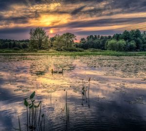 Scenic view of lake against sky during sunset