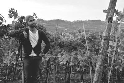 Man standing in vineyard against sky