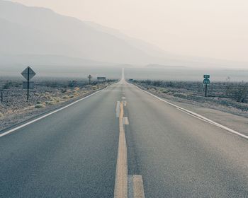 Empty road against sky