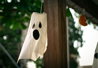 Low angle view of ghost mask hanging from roof during halloween