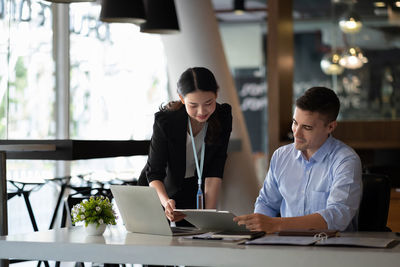 Side view of business colleagues working at office