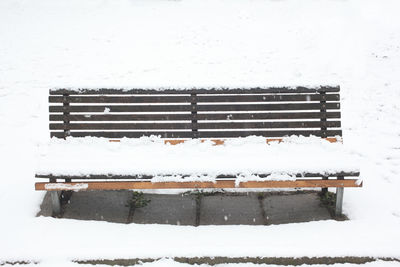 Close-up of snow covered bench