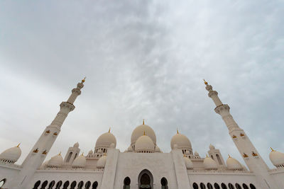 Low angle view of a building against cloudy sky