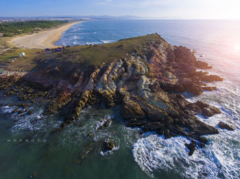 High angle view of rocks on beach against sky