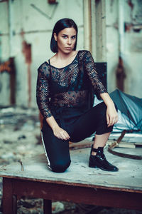 Portrait of young woman in abandoned room