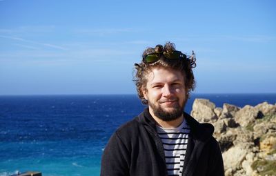 Man standing by sea against clear sky