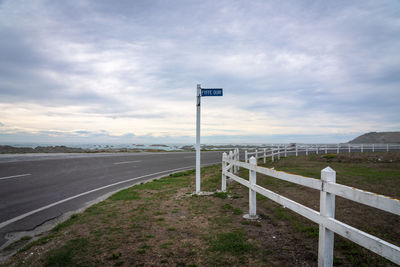 Road signs on land against sky