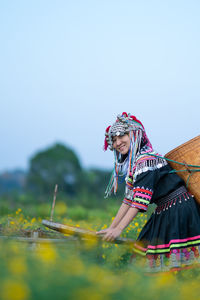 Woman with umbrella against clear sky