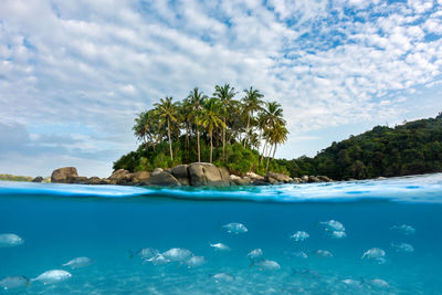 Scenic view of swimming pool by sea against sky