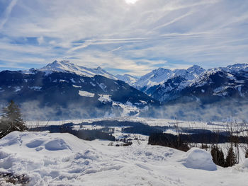 Scenic view of snow covered mountains against sky