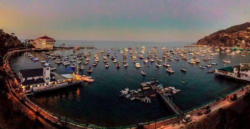 Panoramic view of boats moored in sea against clear sky