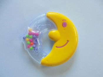 Close-up of yellow toy over white background