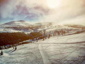 Scenic view of snow covered mountains against sky