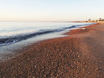 Scenic view of beach against clear sky