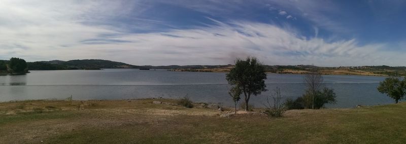 Scenic view of lake against cloudy sky