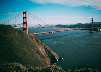 Golden gate bridge over bay against blue sky