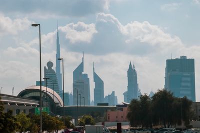 Buildings in city against cloudy sky