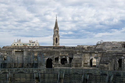 Buildings against cloudy sky