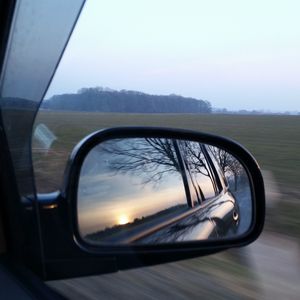 Reflection of car on side-view mirror