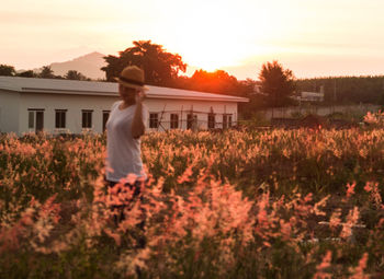 Woman standing on field against clear sky