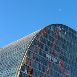 Low angle view of modern building against clear blue sky