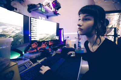 Portrait of young woman using laptop at office