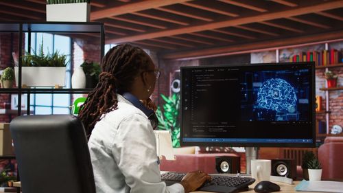 Midsection of woman using laptop at office