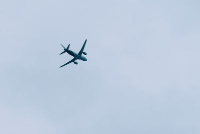 Low angle view of airplane against clear sky