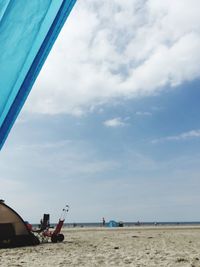 Boats in sea against cloudy sky