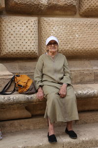 Portrait of smiling woman sitting outdoors