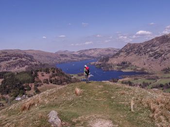 Man standing on mountain against sky