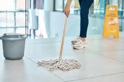 Low section of person standing on hardwood floor