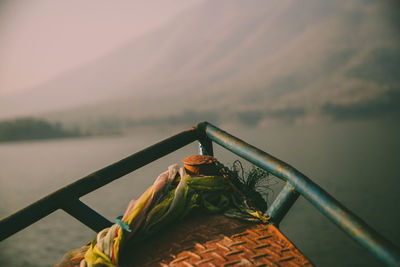 Close-up of boat in lake against sky