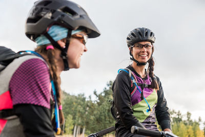 Lauging female mountain biker in meadow