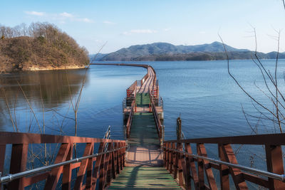 Pier over lake against sky