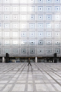 France, ile-de-france, paris, woman walking past arab world institute