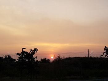 Silhouette trees against sky during sunset